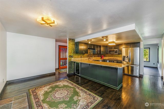 a room with wooden floor and furniture