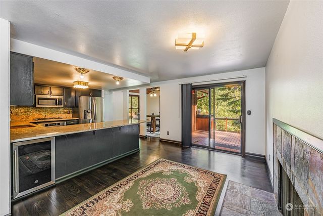 a large room with wooden floor windows and a sink