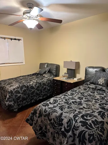 a bedroom with bed and a chandelier