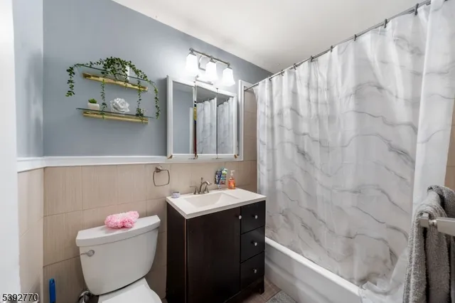 a bathroom with a sink mirror and toilet