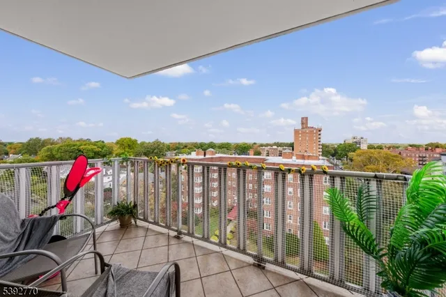 a view of roof deck with wooden floor and fence