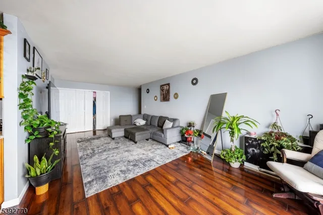 a living room with furniture and flowers