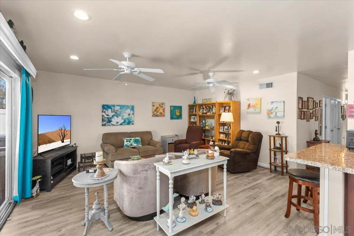 9254 Shadow Hill Road Santee, CA 92071 - Photo 6 of 34 a living room with furniture kitchen view and a wooden floor