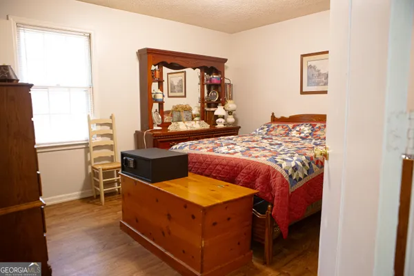 a bed sitting in a bedroom next to a window
