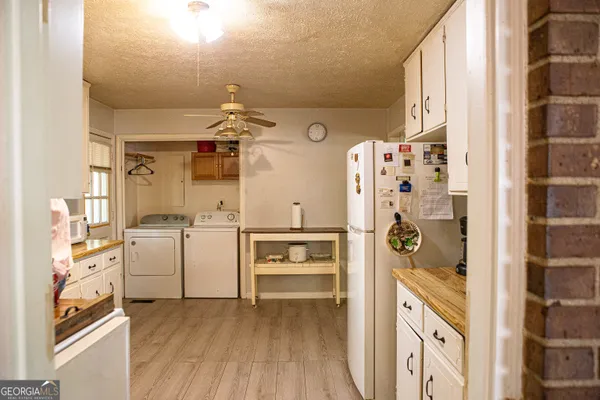 a kitchen with cabinets and wooden floor