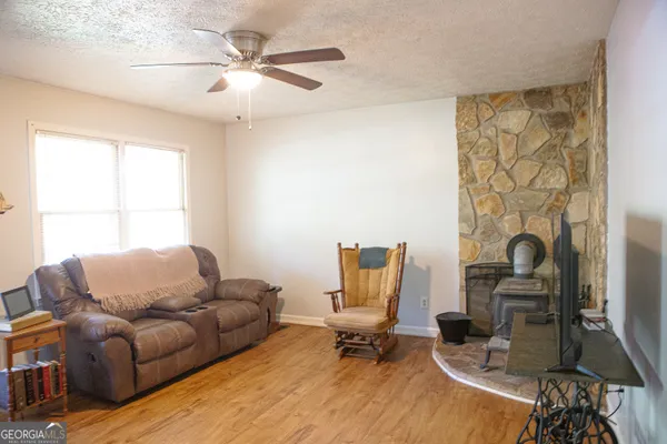 a living room with furniture a dining table and a window