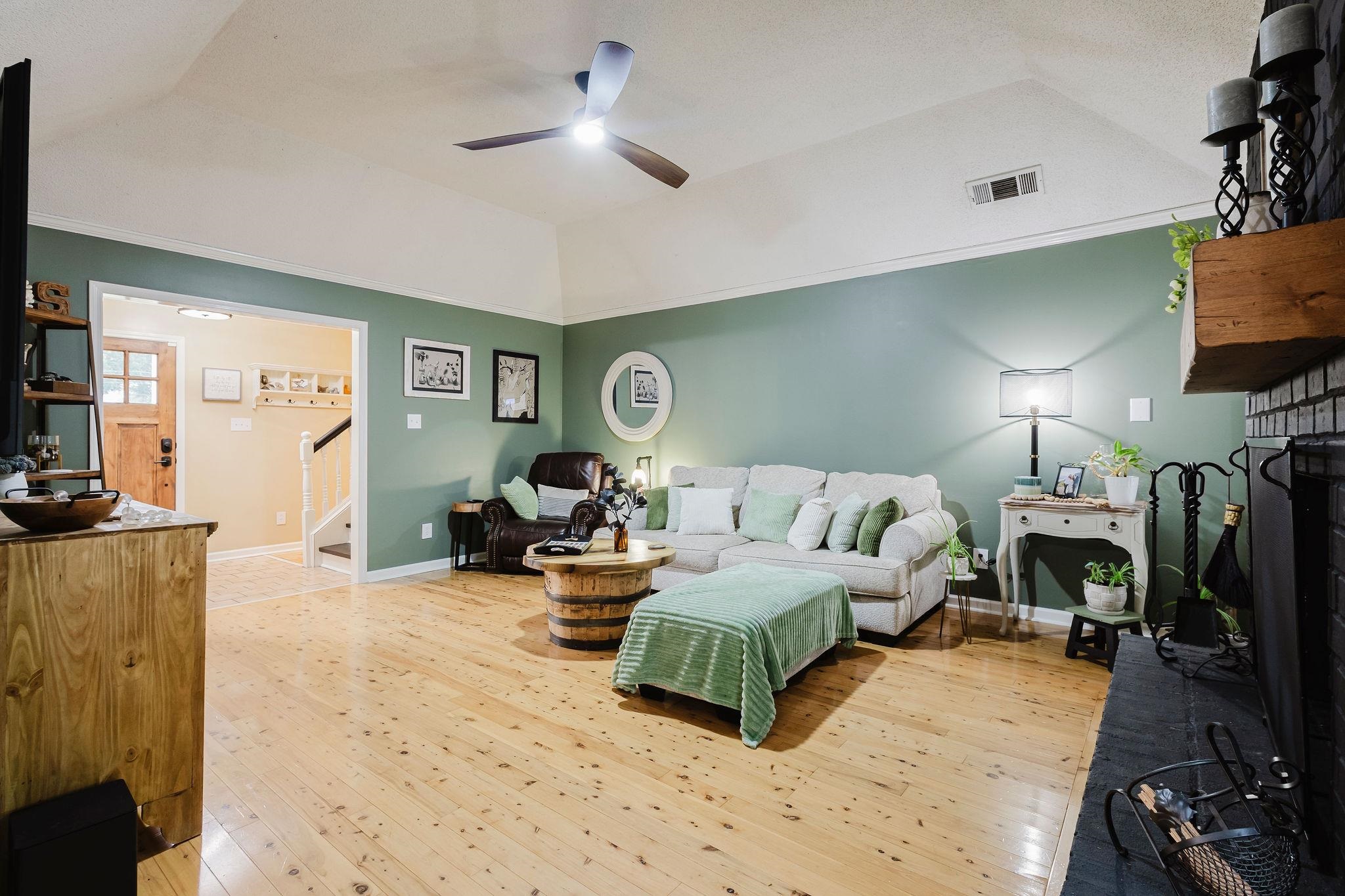 305 Great Falls Road Collierville, TN 38017 - Photo 7 of 23 Spacious living area featuring wood-finish flooring, vaulted ceilings, and a ceiling fan