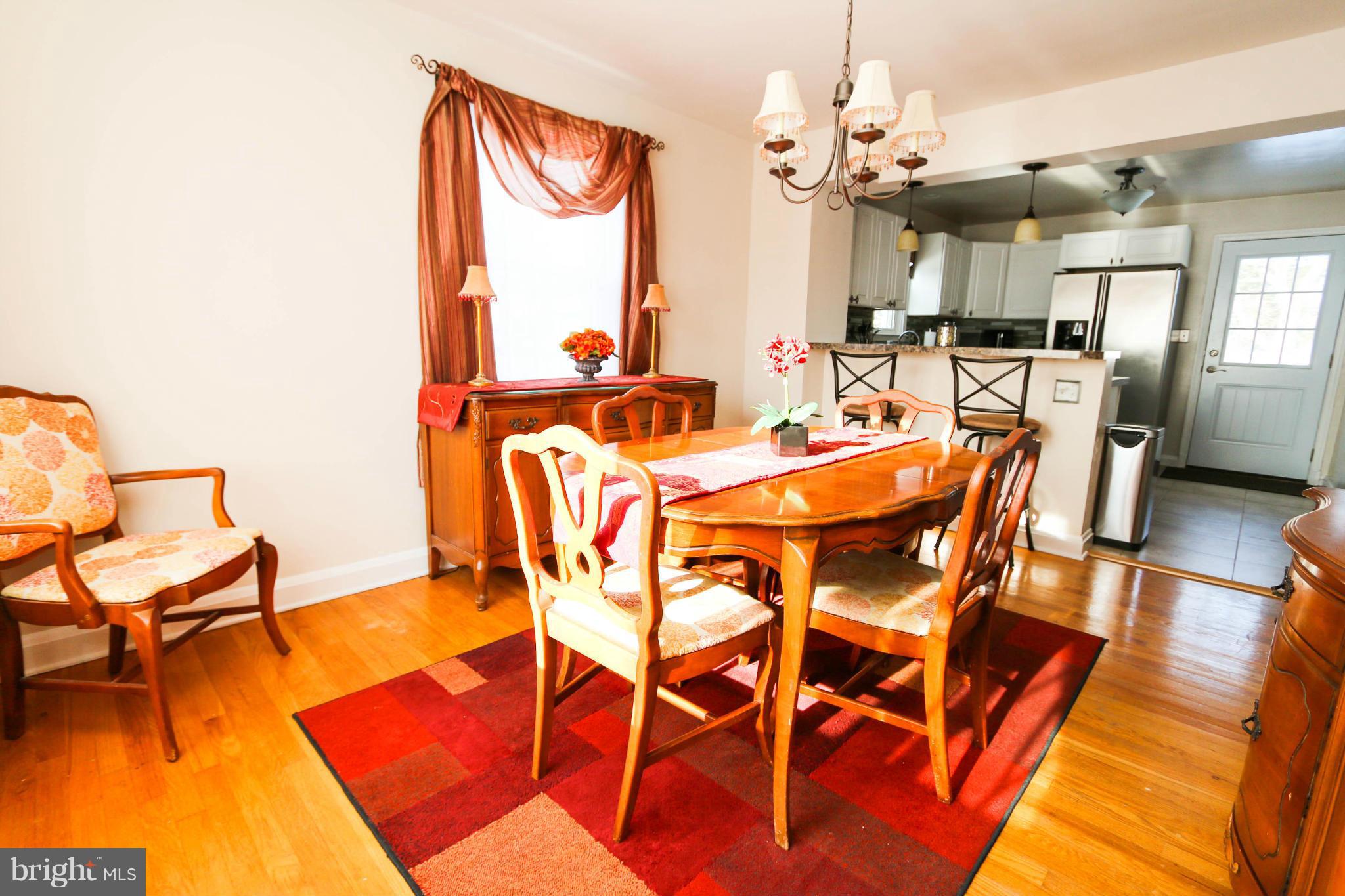 4228 East Joppa Road Baltimore, MD 21236 - Photo 12 of 28 a view of a dining room with furniture and wooden floor