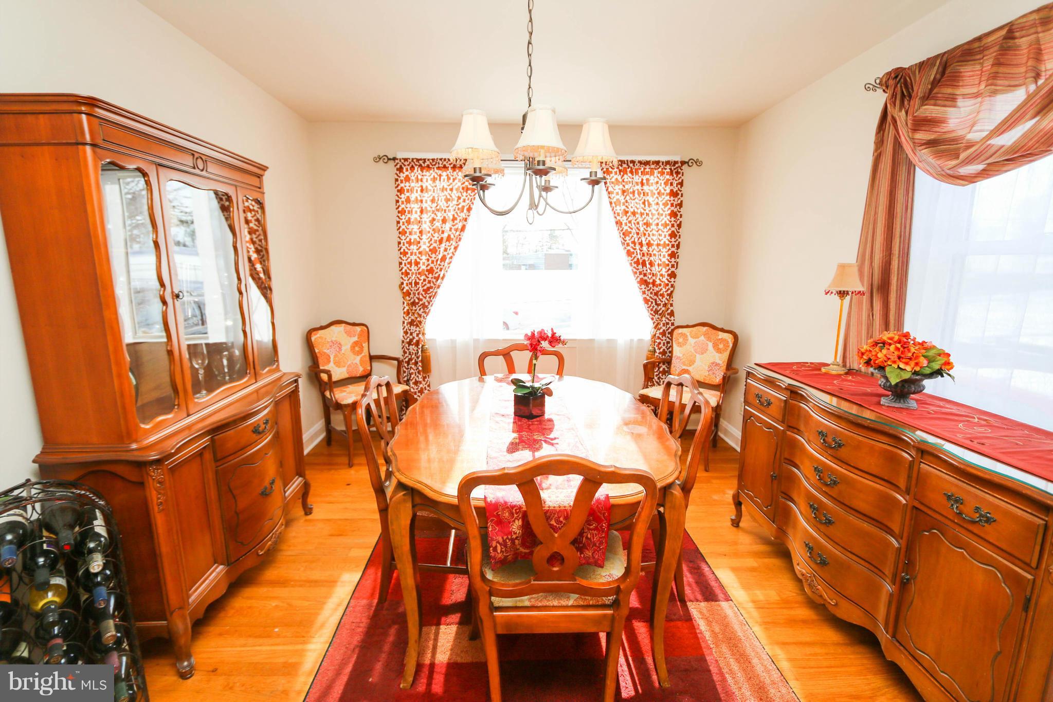 4228 East Joppa Road Baltimore, MD 21236 - Photo 13 of 28 a view of a dining room with furniture and a chandelier