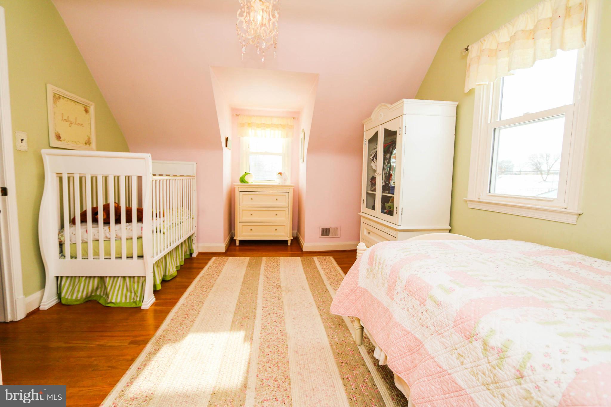 4228 East Joppa Road Baltimore, MD 21236 - Photo 19 of 28 a bedroom with a bed and wooden floor