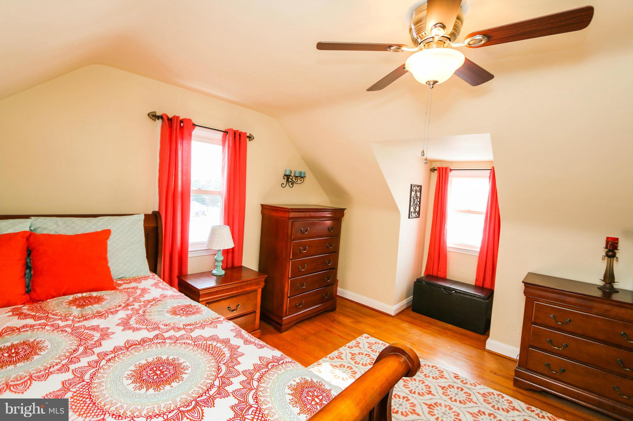 4228 East Joppa Road Baltimore, MD 21236 - Photo 21 of 28 a bedroom with a bed and a chandelier