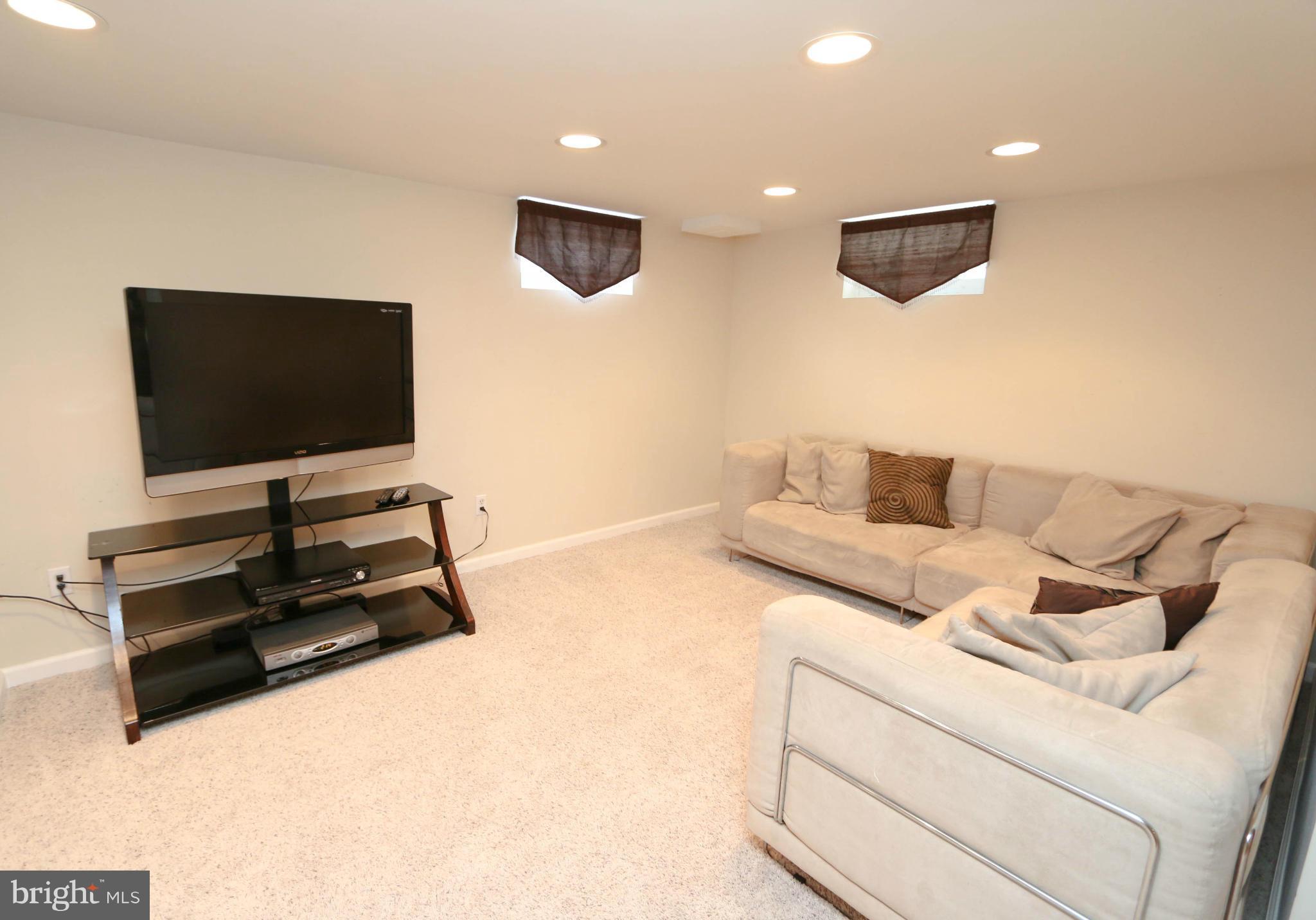 4228 East Joppa Road Baltimore, MD 21236 - Photo 25 of 28 a living room with furniture and a flat screen tv