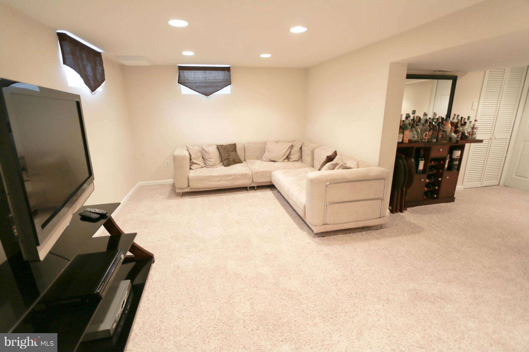 4228 East Joppa Road Baltimore, MD 21236 - Photo 26 of 28 a living room with furniture and a flat screen tv