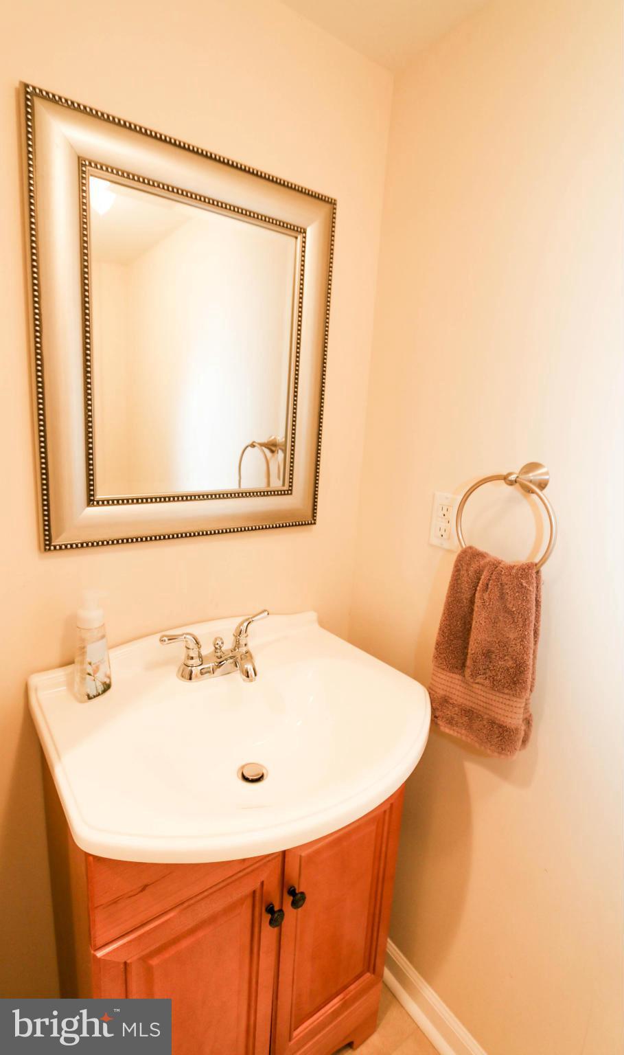 4228 East Joppa Road Baltimore, MD 21236 - Photo 27 of 28 a bathroom with a sink and a mirror