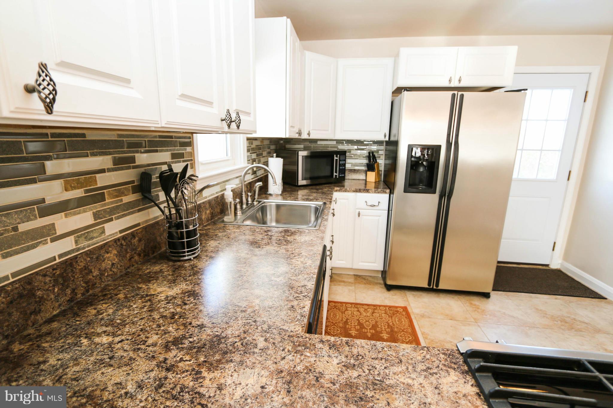 4228 East Joppa Road Baltimore, MD 21236 - Photo 10 of 28 a kitchen with stainless steel appliances a refrigerator a stove and white cabinets