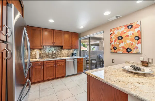 a kitchen with stainless steel appliances granite countertop a sink and cabinets