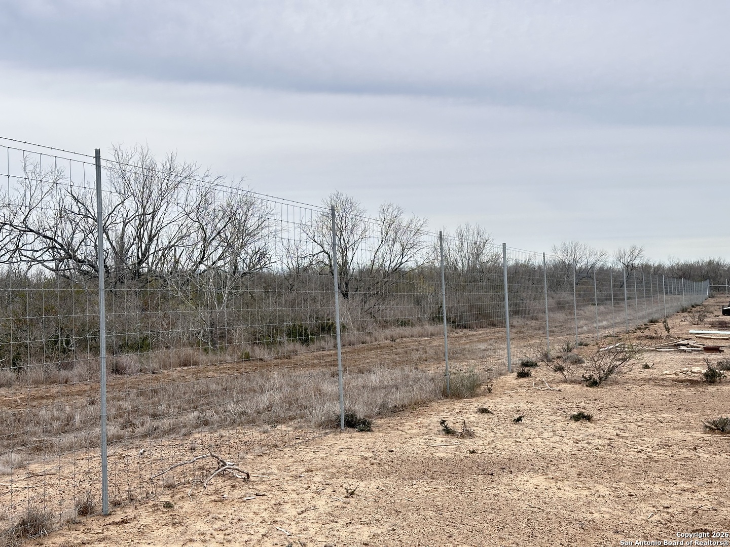 354-easement County Road Charlotte, TX 78011 - Photo 3 of 38 a view of a dry yard with wooden fence