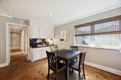 a kitchen with a table and chairs in it