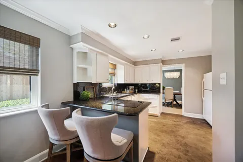 a dining room with furniture a window and kitchen view
