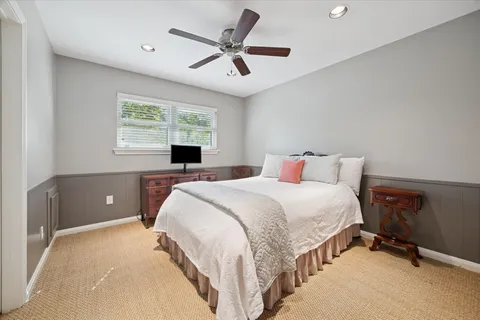 a bedroom with a large bed and a window