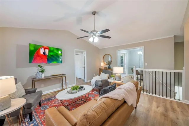 a living room with furniture a chandelier and a painting