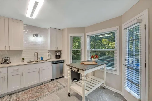 a kitchen that has a sink and a stove in it