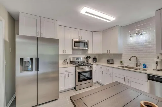 a kitchen with a sink stove and refrigerator