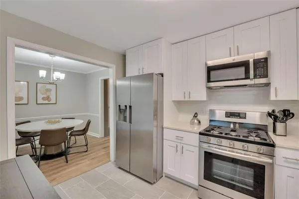 a kitchen with stainless steel appliances a stove a microwave and a refrigerator