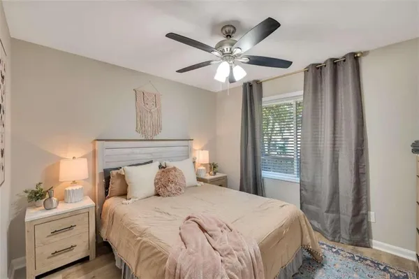 a bedroom with a large bed and a chandelier
