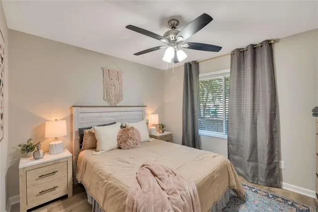 a bedroom with a large bed and a chandelier