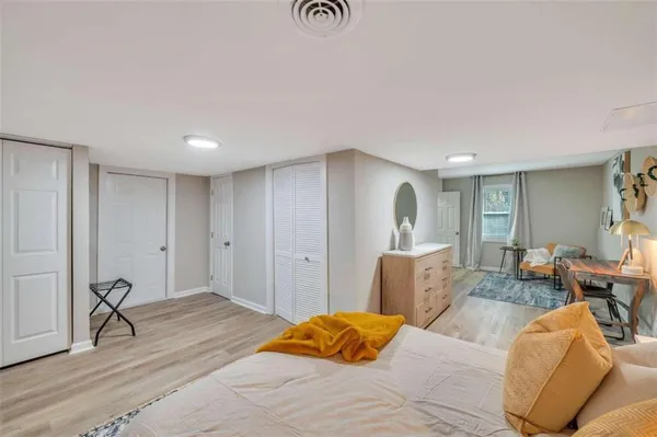 a bedroom with a bed and wooden floor