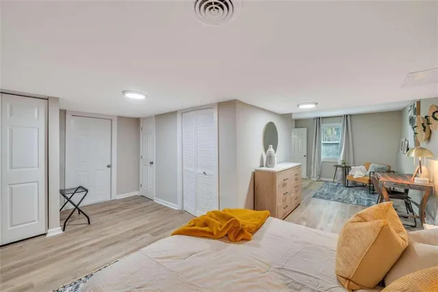 a bedroom with a bed and wooden floor