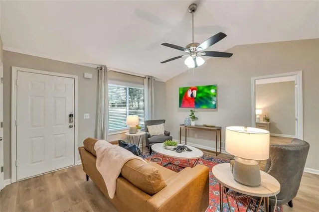 a living room with furniture a chandelier and a window