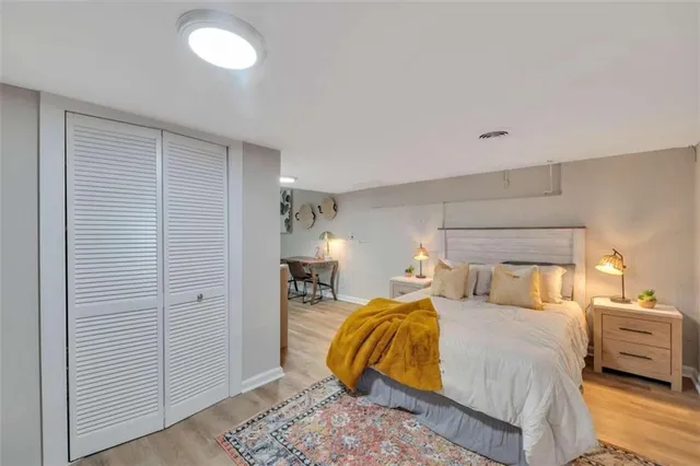 a bedroom with a bed and a lamp