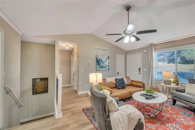 a dining room with furniture a flat screen tv and a chandelier
