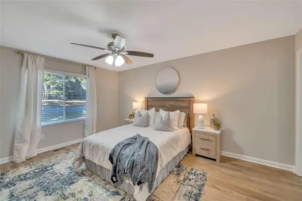 a bedroom with a bed and a window