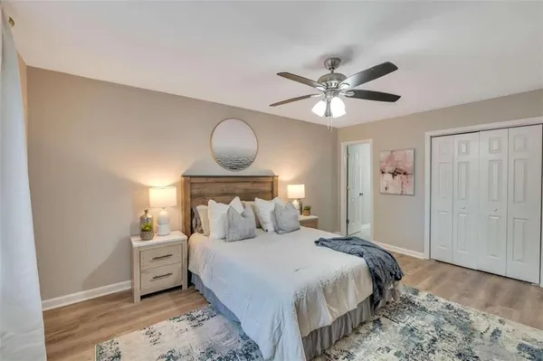 a bedroom with a bed and a chandelier
