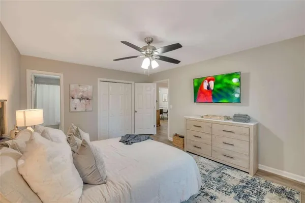 a bedroom with a bed and a flat screen tv