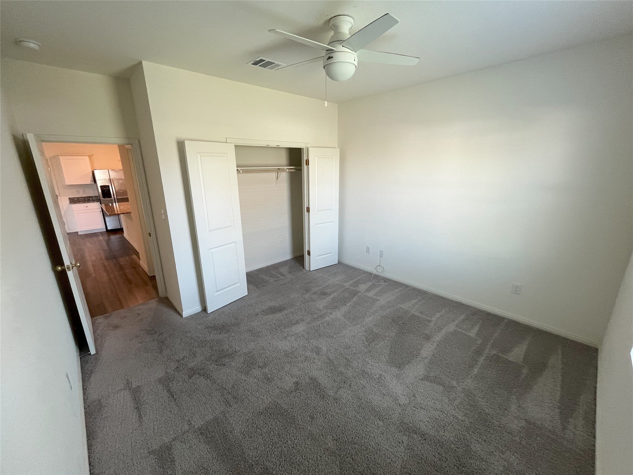215 Light Timber Road Maxwell, TX 78656 - Photo 8 of 33 Plush wall-to-wall carpeting and neutral walls define this cozy bedroom retreat.
