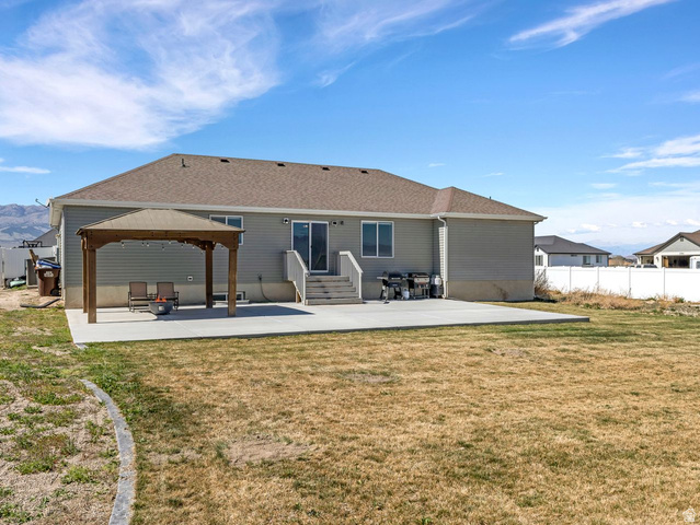 573 South Maxwell Drive Grantsville, UT 84029 - Photo 24 of 25 Back of property featuring a patio, a gazebo, entry steps, and a shingled roof