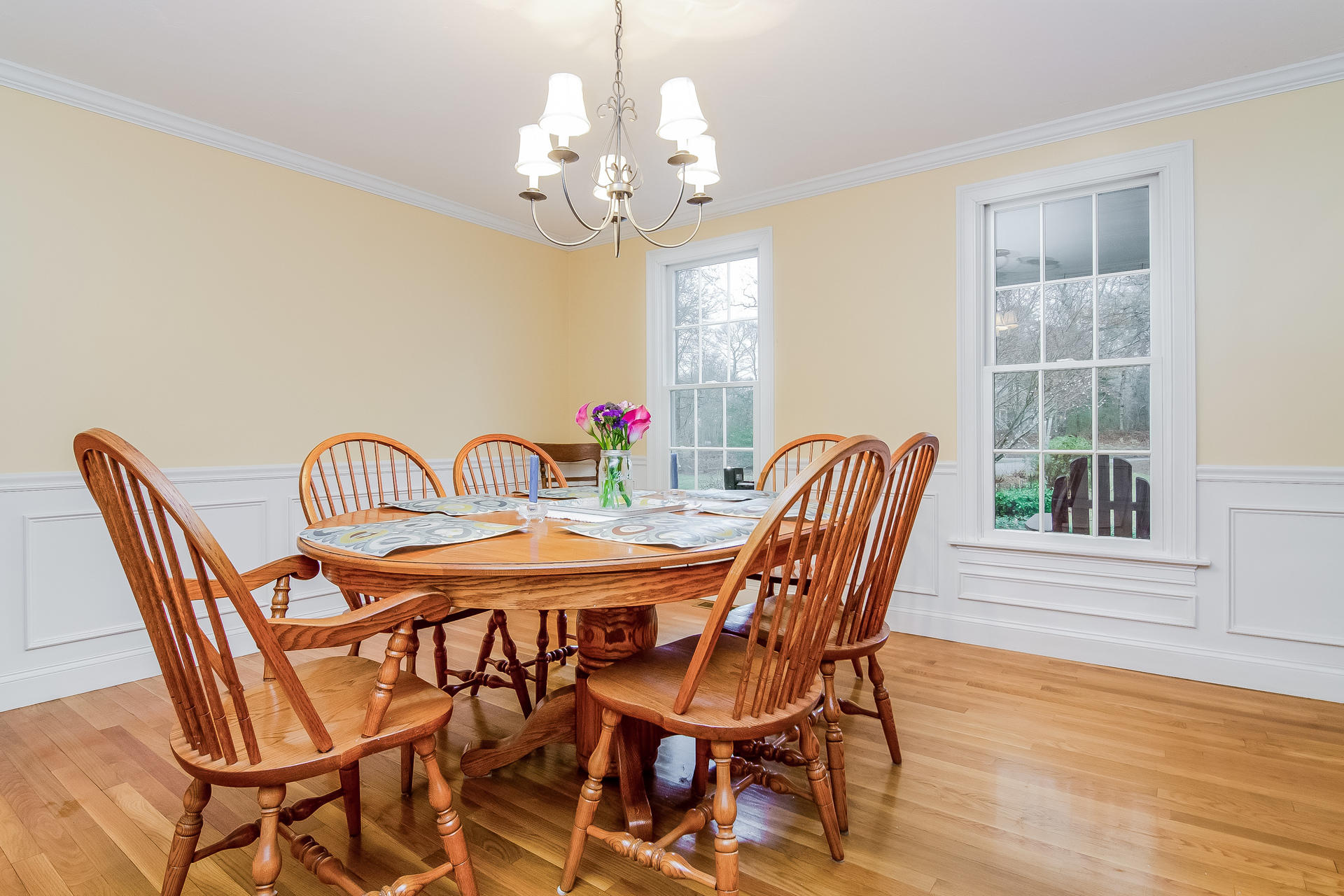 40 Chipman Road Sandwich, MA 02563 - Photo 17 of 26 a view of a dining room with furniture a chandelier and wooden floor