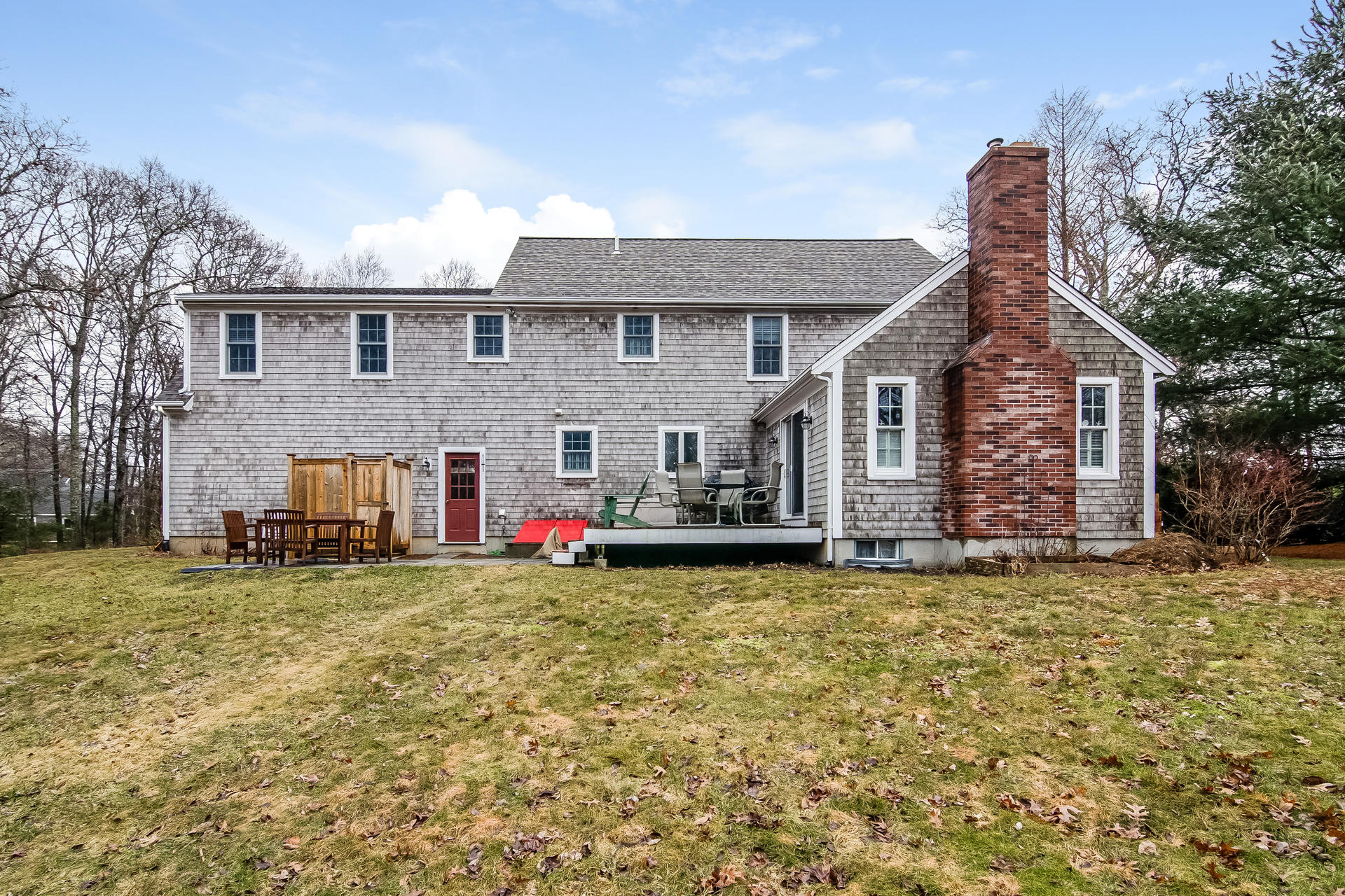 40 Chipman Road Sandwich, MA 02563 - Photo 5 of 26 a front view of house with yard and trees in the background