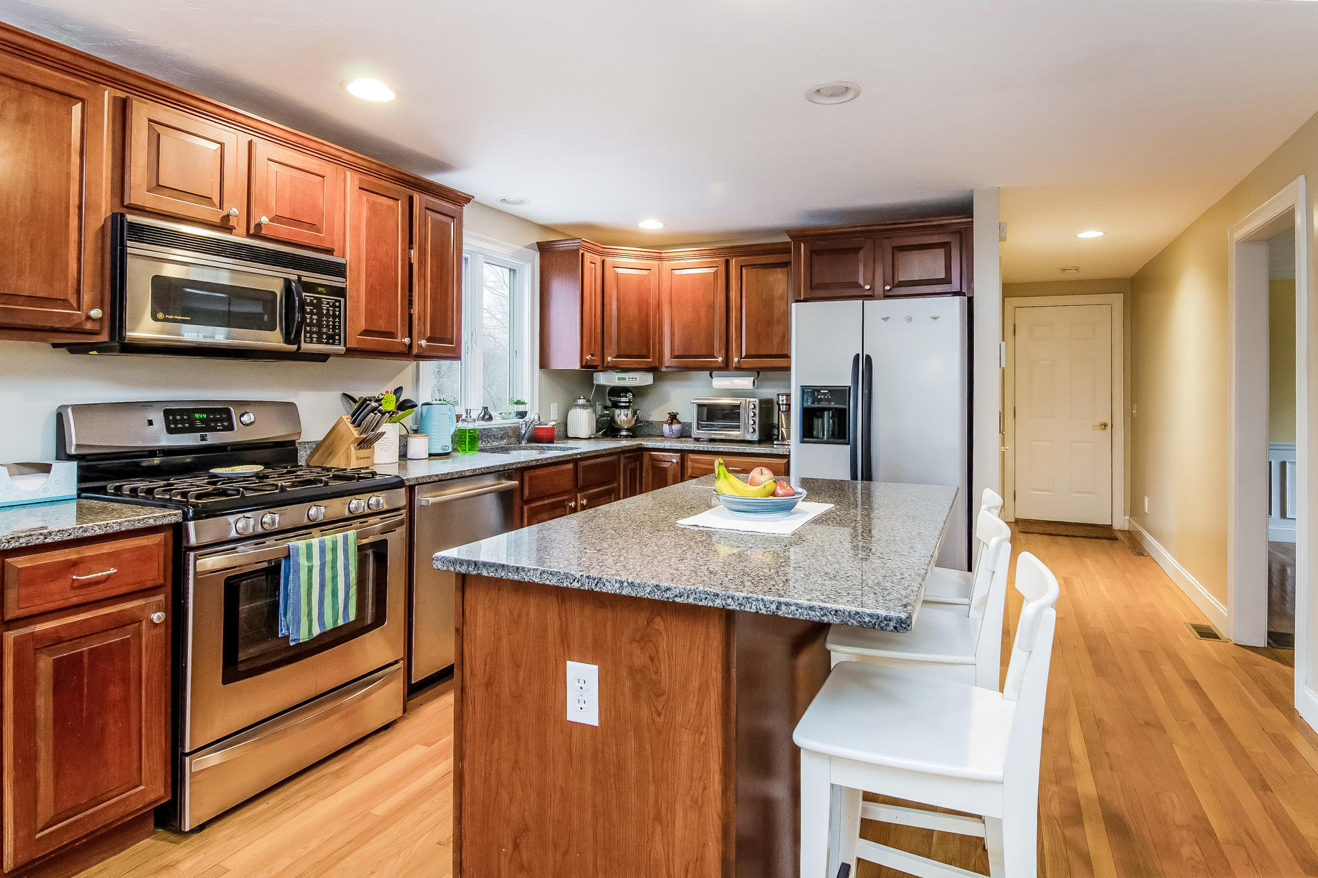 40 Chipman Road Sandwich, MA 02563 - Photo 8 of 26 a kitchen with stainless steel appliances granite countertop a stove a sink and a microwave