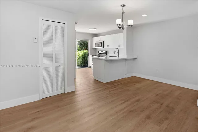 a view of a kitchen and an empty room