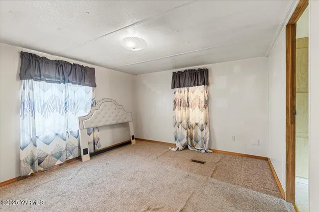 a room that has a bed and a chair in it