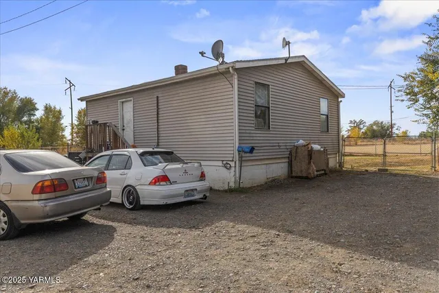 a couple of cars parked in front of a house