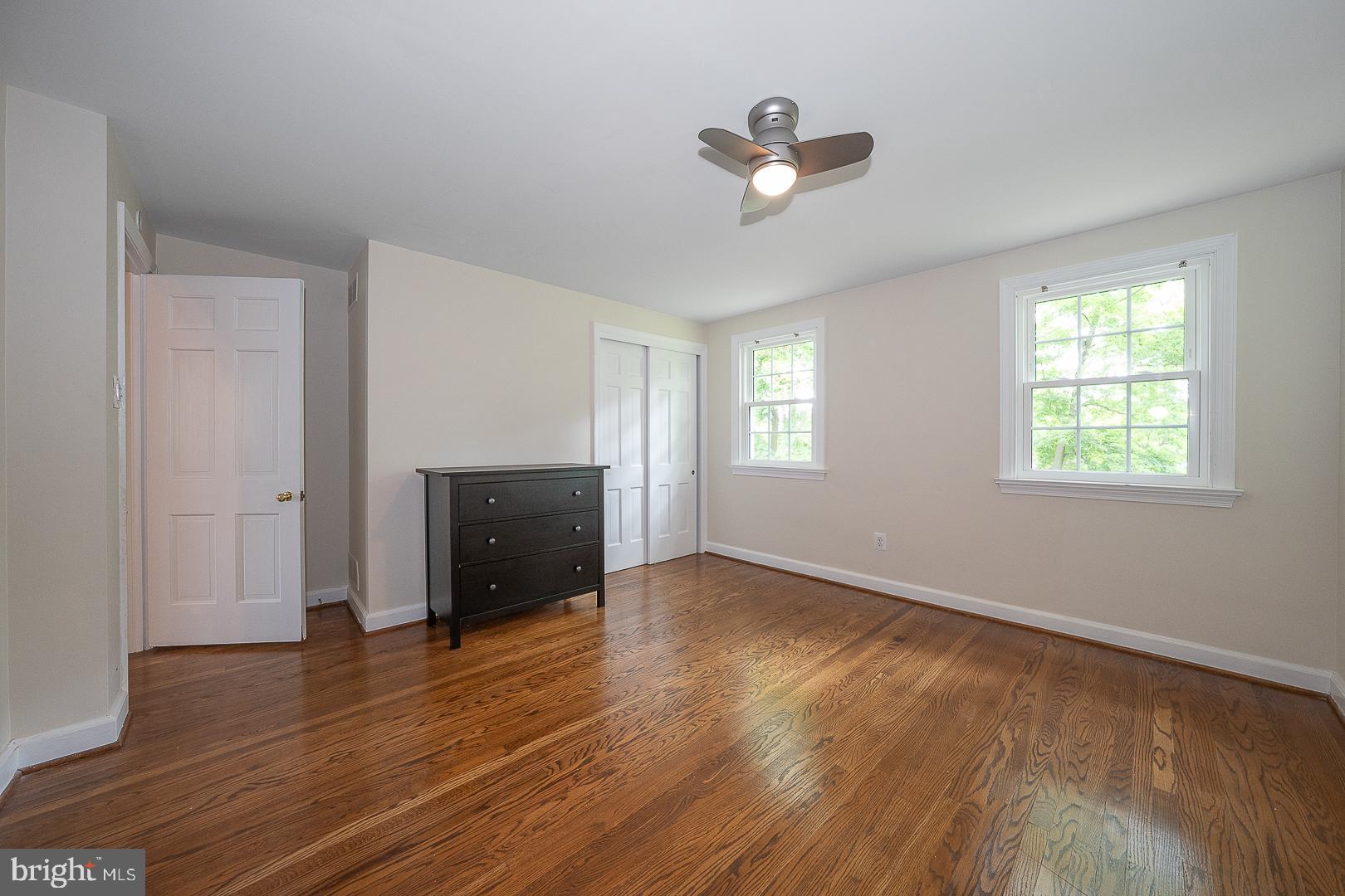 538 Conestoga Road Villanova, PA 19085 - Photo 27 of 39 an empty room with wooden floor chandelier and windows