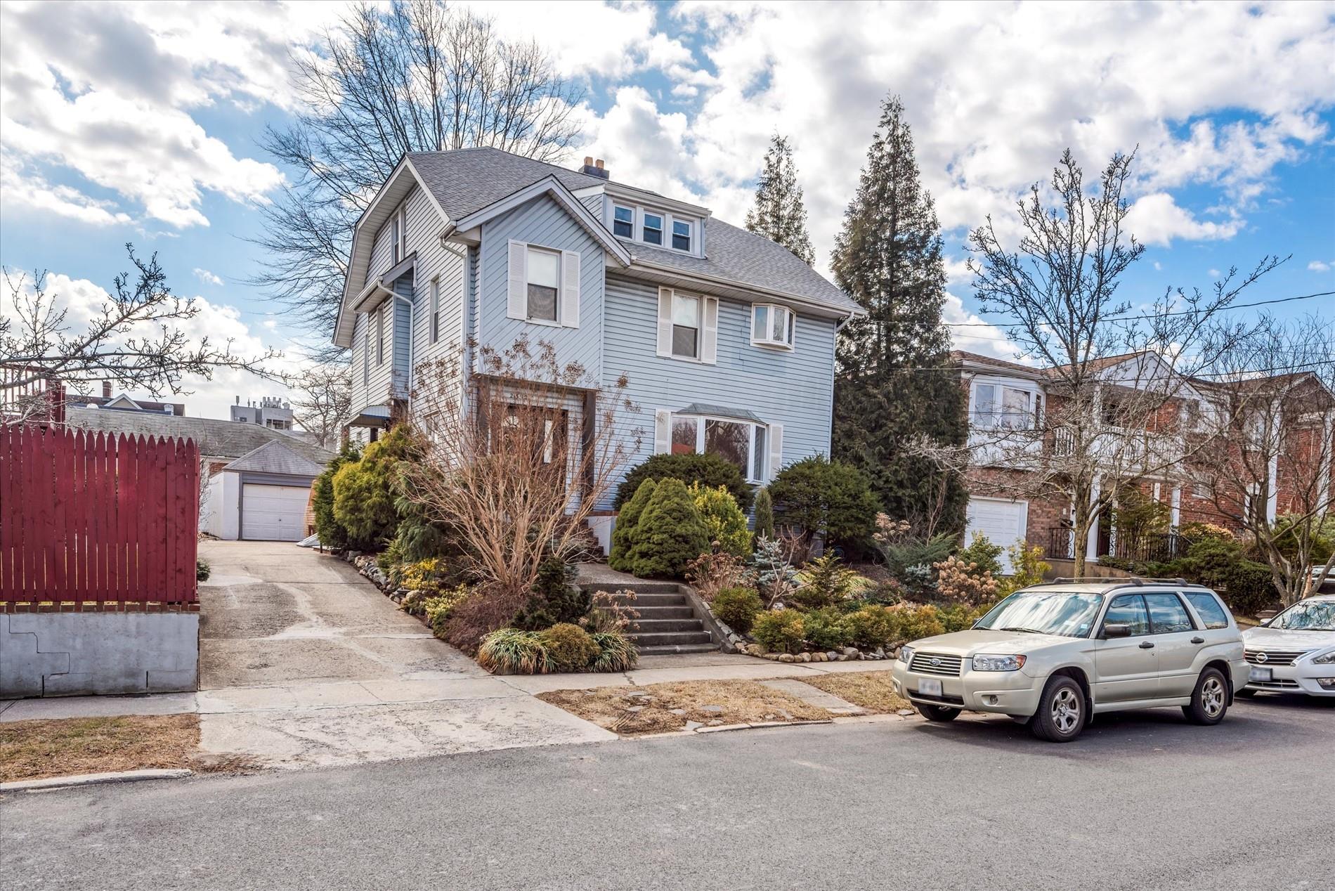 213-12 33rd Road Queens, NY 11361 - Photo 1 of 1 a car parked in front of a house