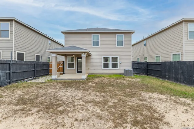 a view of a house with a backyard and balcony