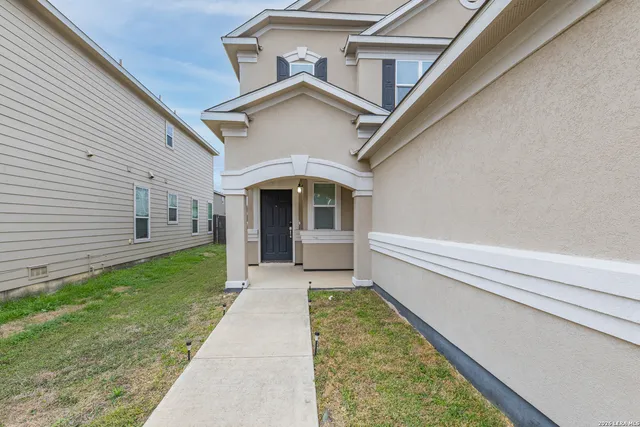 a view of house with backyard